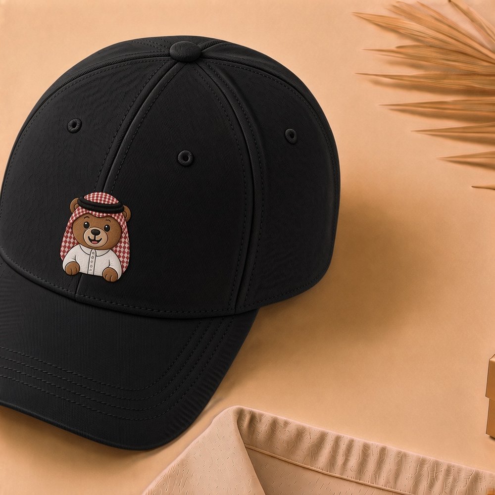 Shadu Embroidered Cap in black with the boy bear in a red ghutra